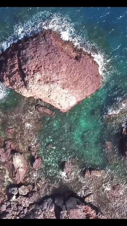 Breathtaking aerial top-down view of a stunning rocky coastline with turquoise Stock Footage 344396139