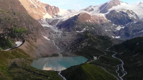 Breathtaking Aerial View of Glacial Alpine Lake in High Mountains Видео 329056499