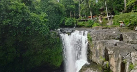 Breathtaking aerial view of a lush waterfall in a forest Stock Footage 274524002