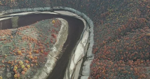 Breathtaking aerial view of mountain curved river framed by lush forested slo Stock-Footage 330696341