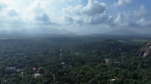 Breathtaking aerial view of a rock formation amidst lush greenery Stock Footage 302232644
