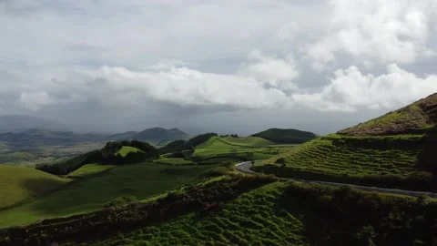 Breathtaking Aerial View of Rolling Green Hills Under Cloudy Skies in Azores 库存影片 301734491