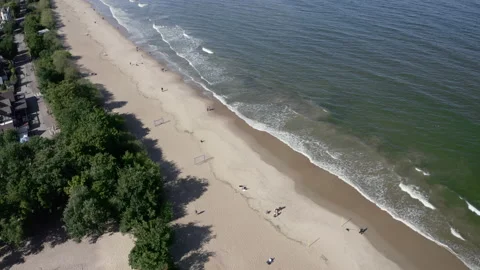 Breathtaking Aerial View Of Sandy Beach And People Taking A Walk On The Coast Stock Footage 143851767
