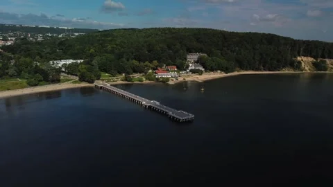 A breathtaking aerial view showcases a serene pier extending gracefully into Video stock 289476653