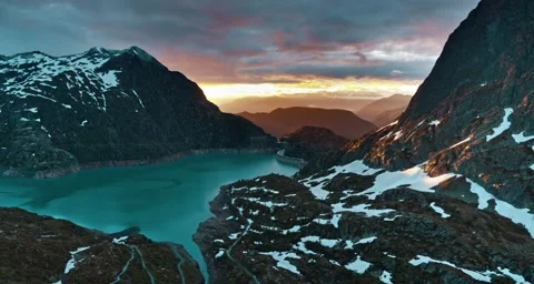 Breathtaking Aerial View of Snow-Capped Mountains at Sunrise Stock Footage 323301116