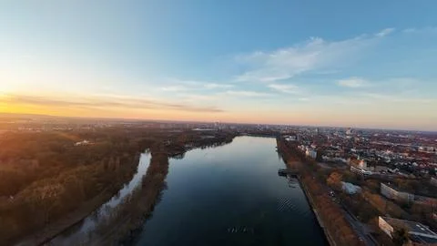 Breathtaking Aerial View at Sunset, Capturing the River Flowing Through Urban Stock Photos
