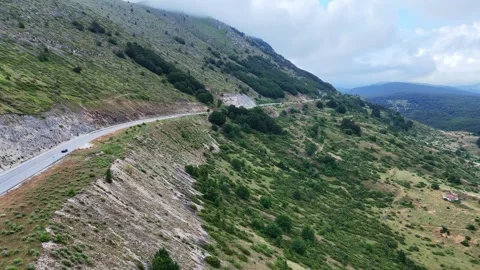 Breathtaking Aerial View of A Winding Mountain Road Surrounded by Lush Green Video stock 281278053