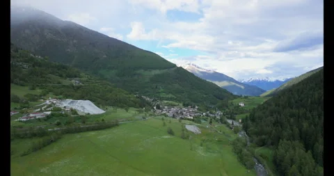 Breathtaking aerial views capturing the serenity of a mountain village nestled Video stock 314080242
