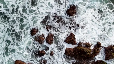 Breathtaking aerial of waves breaking on rocks along a remote rugged coastline. Stock Footage 308695671