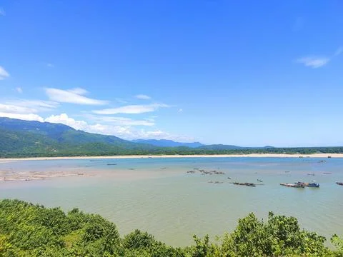 A Breathtaking Beachscape with Towering Mountain Backdrop Stock Photos