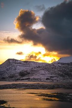 Breathtaking blaze of the setting sun over the fjords and snow-covered moun.. Stock-Fotos