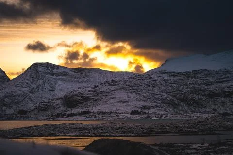 Breathtaking blaze of the setting sun over the fjords and snow-covered moun.. Stock-Fotos