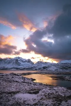 Breathtaking blaze of the setting sun over the fjords and snow-covered moun.. Stock-Fotos