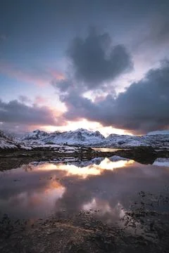Breathtaking blaze of the setting sun over the fjords and snow-covered moun.. Stock-Fotos