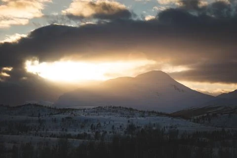 Breathtaking blaze of the setting sun over the fjords and snow-covered moun.. Stock-Fotos