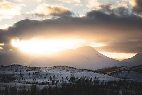 Breathtaking blaze of the setting sun over the fjords and snow-covered moun.. Stock-Fotos