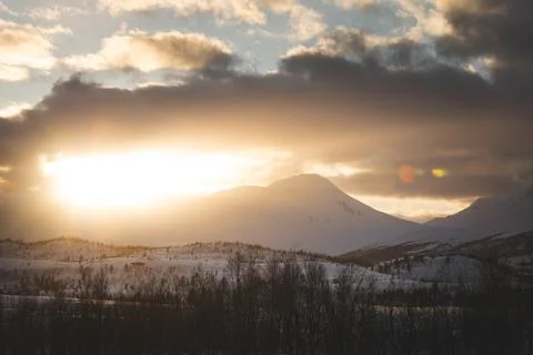 Breathtaking blaze of the setting sun over the fjords and snow-covered moun.. Stock-Fotos