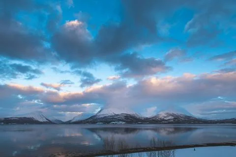 Breathtaking blaze of the setting sun over the fjords and snow-covered moun.. Stock-Fotos