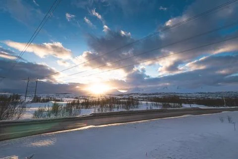Breathtaking blaze of the setting sun over the fjords and snow-covered moun.. Stock-Fotos