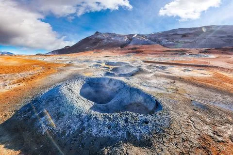 Breathtaking boiling mudpots in geothermal area Hverir and cracked ground a.. Stock Photos