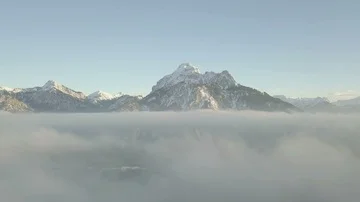 Breathtaking camera flight above the clouds toward the mountains Stock Footage 86139891