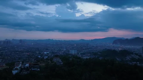 Breathtaking Cityscape at Dusk with Clouds and Urban Lights Stock Footage 312143289
