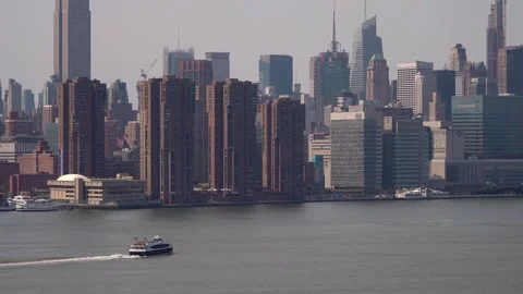 A breathtaking cityscape view showcasing a ferry navigating through serene Stock Footage 314577687