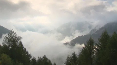 Breathtaking clouds surrounding mountains Stock Footage 59318743