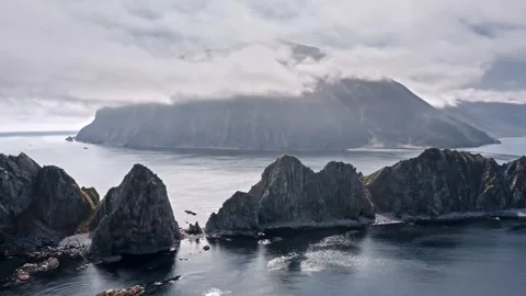Breathtaking coastal view of rocky cliffs and tranquil waters 스톡 동영상 320293367