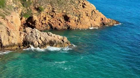 Breathtaking Coastal View Showcases Dramatic Rocky Outcrop and Sparkling Cr.. Stock Photos