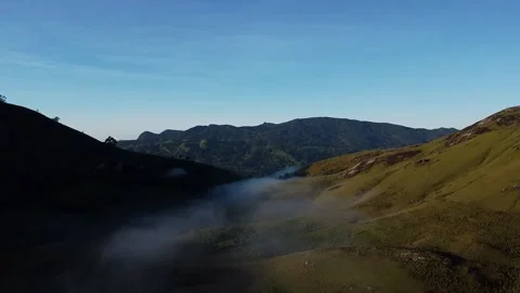 Breathtaking drone shot capturing a vast expanse of lush, green mountains Video stock 306727394