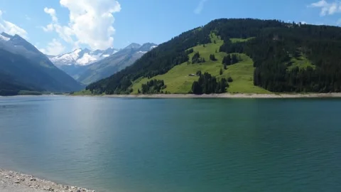 Breathtaking Drone View of Serene Alpine Lake and Majestic Mountains with G.. Stock Footage 337042765