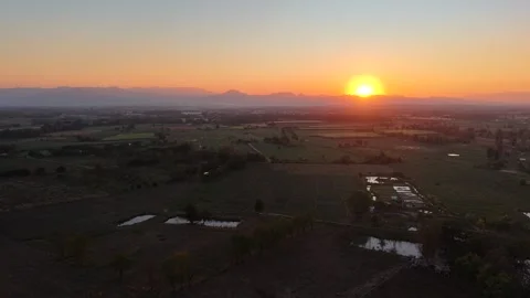 Breathtaking Evening Landscape of Vast Fields and Hazy Mountains Stock Footage 326176490