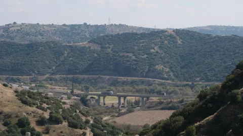 A breathtaking landscape showcasing rolling hills, a highway Stock Footage 322970739
