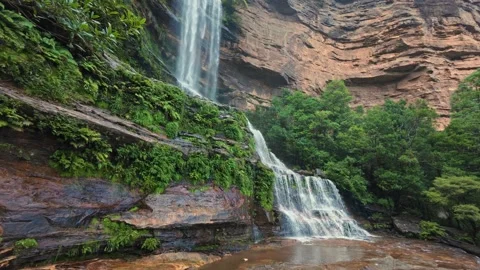 Breathtaking low-angle waterfall footage showing cascading waters over rocky Stock Footage 315672389