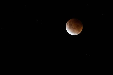 Breathtaking lunar eclipse against a dark background - perfect for wallpapers Stock Photos
