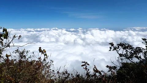Breathtaking Mountain Cloudscape Above the Clouds with Blue Sky Stock Photos