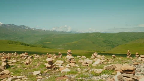 Breathtaking mountain landscape with green fields and rocky formations near a 動画素材 313106988