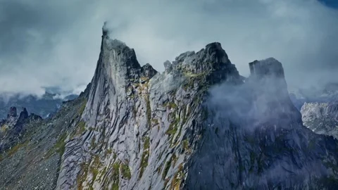 Breathtaking Mountain Peaks Under Dramatic Cloudy Skies Stock Footage 323301489