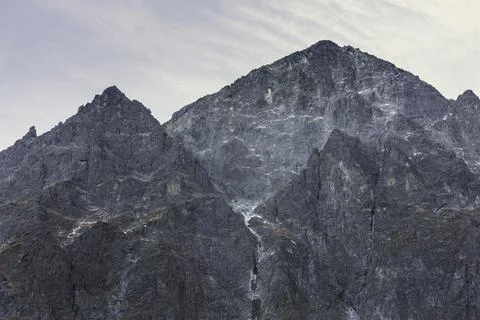 Breathtaking mountain range with clear sky, snow-capped peaks, and a serene.. Stock Photos