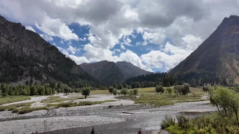 Breathtaking Mountain Range with River Flowing through Lush Green Landscape, Stock Footage 287999438