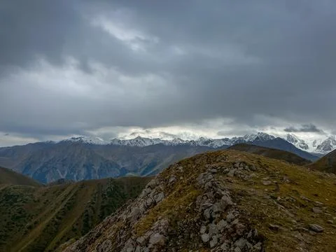 Breathtaking Mountain Scenery Under Dramatic Clouds Highlighting Majestic P.. Stock Photos