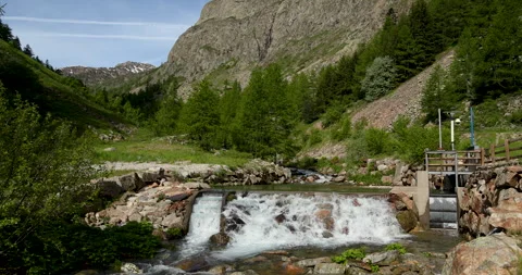 Breathtaking mountain stream cascades through lush greenery in tranquil alpine Stockbeeldmateriaal 314082064