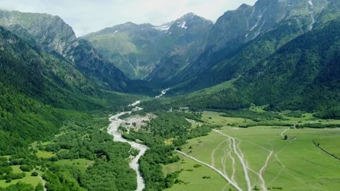 Breathtaking mountain valley with winding river and lush greenery Stock Footage 301233125