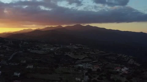 A breathtaking mountainous landscape at sunset with rugged peaks, vibrant orange 動画素材 309622963