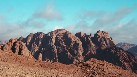 A breathtaking Mousa mountain landscape with clouds drifting over red sandstone  Stock Footage 329236294