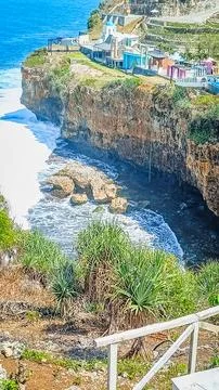 Breathtaking Ocean Cliffside View With Waves Crashing Below Stock Photos