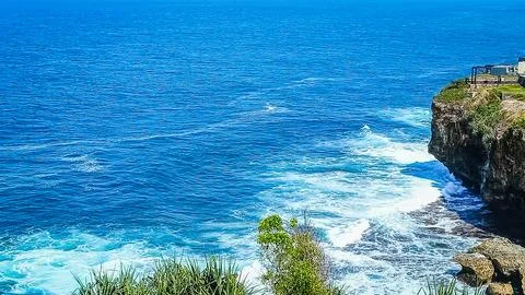 Breathtaking Ocean Cliffside View With Waves Crashing Below Stock Photos