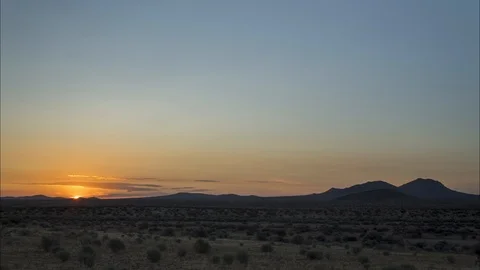 Breathtaking orange sunrise time lapse over scenic Mojave Desert landscape Stock Footage 113700931
