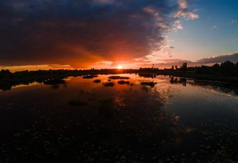 Breathtaking panoramic sunset over a tranquil marshland, vivid orange and p.. Stock Photos